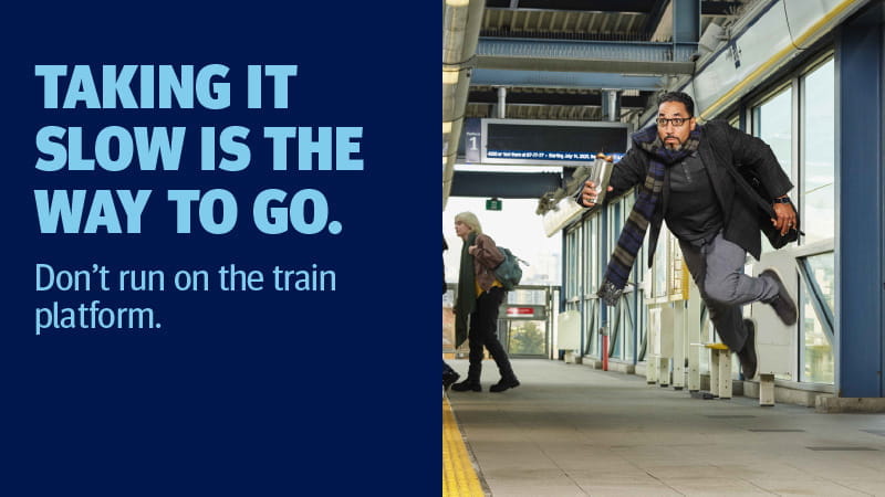A man running towards the train platform in a hurry.